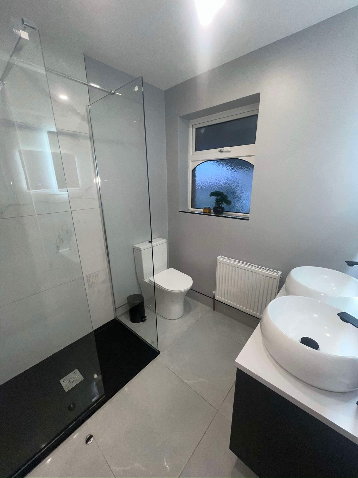 Bathroom with walk-in shower and twin basins