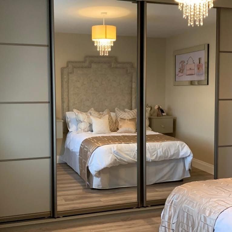Champagne-framed mirrored sliding wardrobes