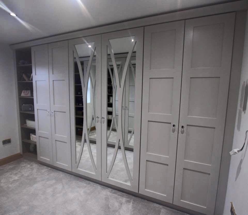 Dove-grey shaker fitted wardrobes with open shelving