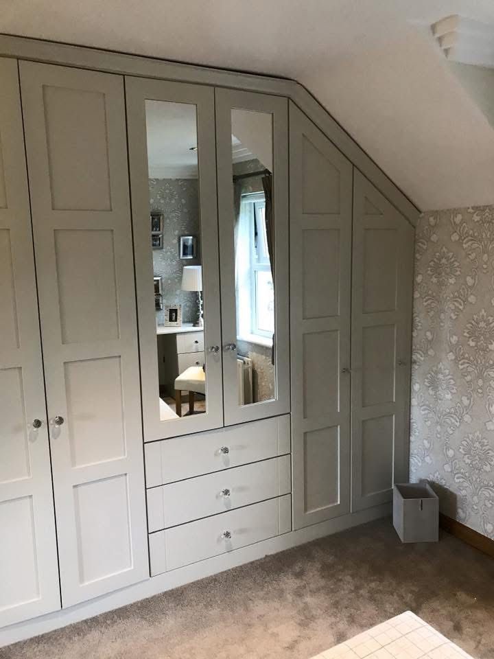 Shaker wardrobes fitted into sloped attic eaves