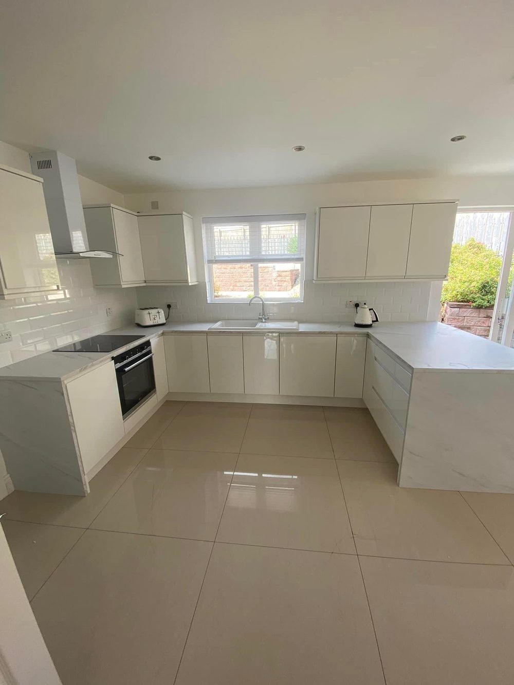 Bespoke cream gloss kitchen designed and fitted by ESK